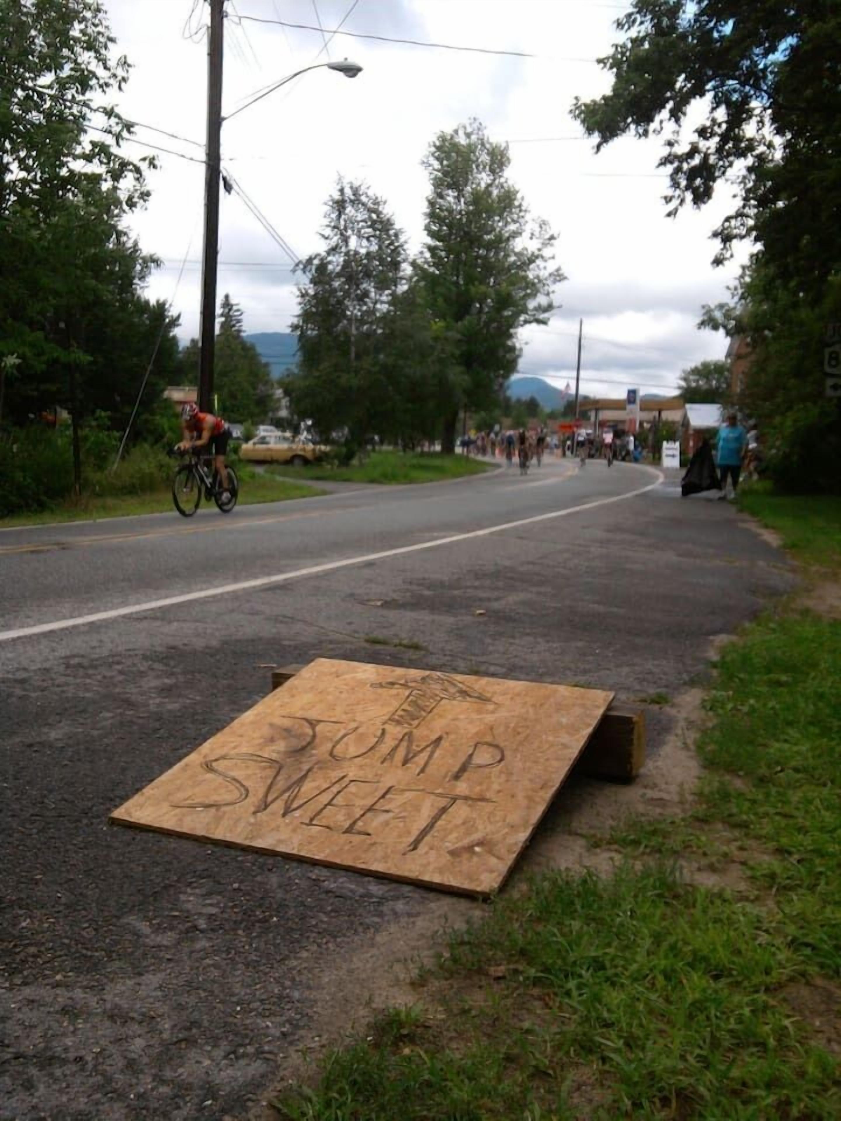 A road with a cardboard sign on the side.