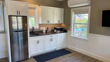 Fridge, microwave, coffee/tea maker, cookware/dishes/utensils