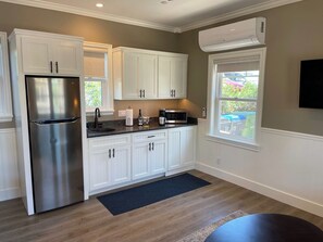 Fridge, microwave, coffee/tea maker, cookware/dishes/utensils