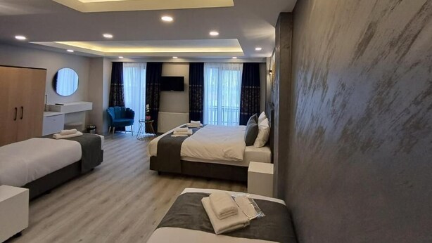 Una habitación de hotel moderna con dos camas, un escritorio y un área de estar.