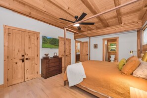 Un dormitorio con cama, armario de madera, cómoda y ventilador de techo.