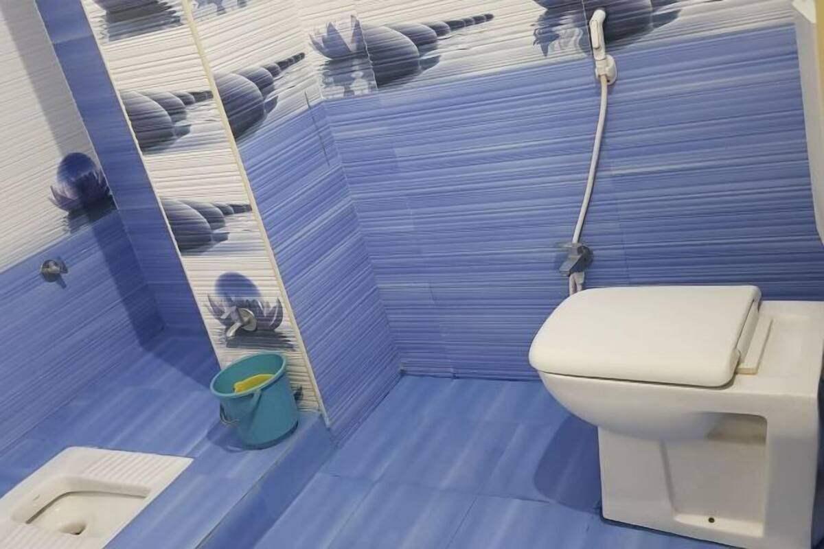 A bathroom with a toilet, a bidet, and a shower.