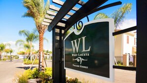 A sign for West Lucaya Village Resort with a pergola structure. - Spacious 4BR TownHome in Kissimmee, perfect for family getaways! (Kissimmee)