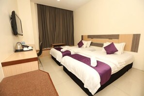 A hotel room with two beds, a desk with a kettle, a TV, and a large window with curtains. - MY Fame Hotel (Rasah)