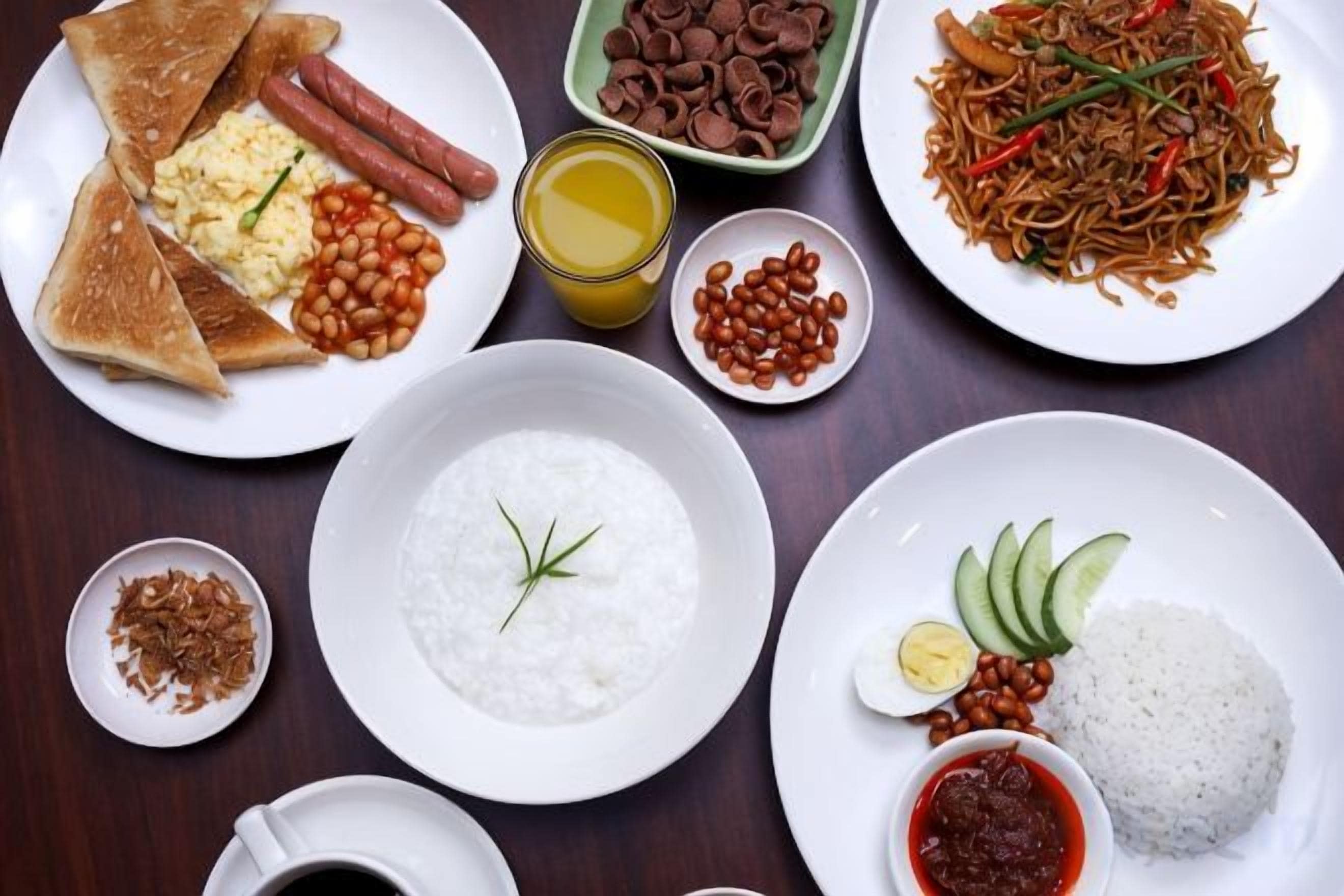 A variety of dishes including rice, eggs, and noodles, suggesting a diverse meal selection.