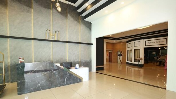 A modern lobby with a reception desk, a MyName De'Café, and a clean, tiled floor. - MY Fame Hotel (Rasah)