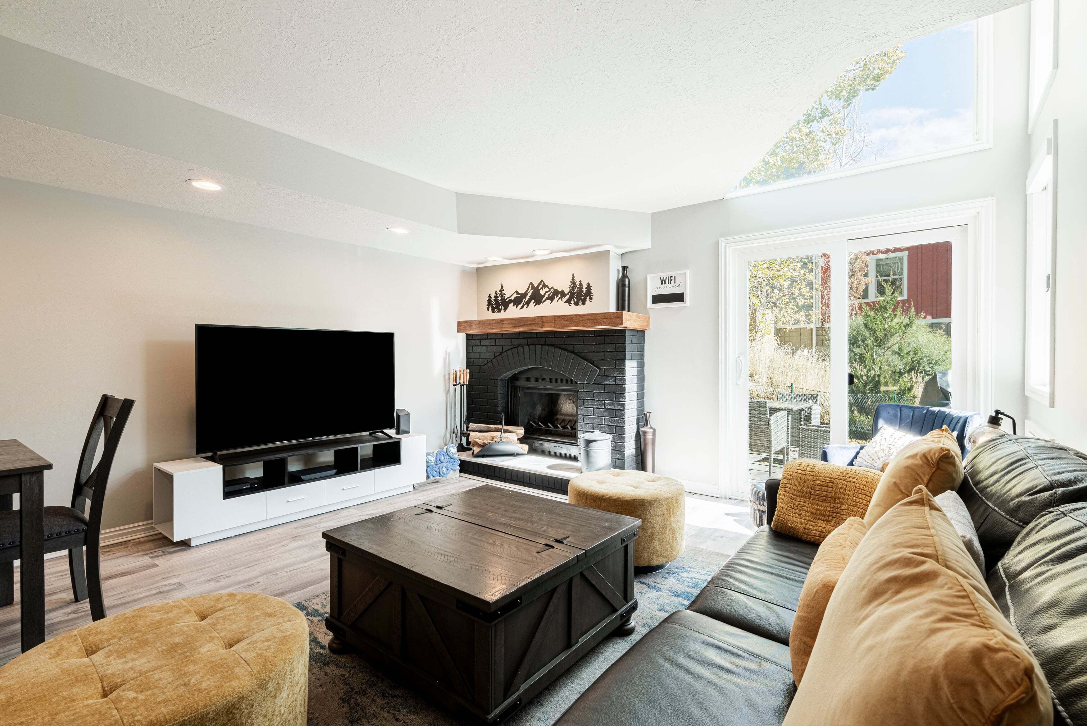 A living room with a fireplace, a flat-screen TV, a sofa, and a coffee table.