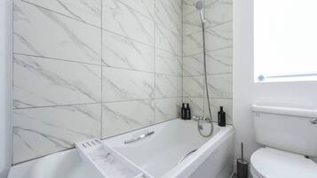 Shower, hair dryer, towels, shampoo