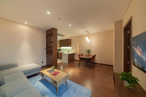 King Room with Balcony | Living area | 43-inch LCD TV with cable channels - DHTS Business Hotel & Apartment (Ho Chi Minh City)