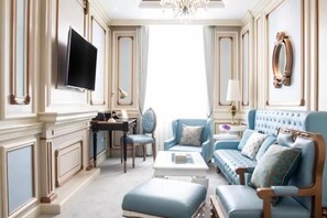 Relax in style with a large flat-screen TV, comfortable sofa, and matching armchair.