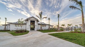A single-story house with a front entrance, a driveway, and a well-maintained lawn. - Condo 5896 at Heritage Landing: Relax & Unwind Here (Charlotte County)