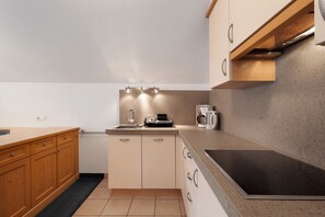A modern kitchen with wooden cabinets, a stainless steel sink, and a built-in oven. - Apartment 'Loderhof Sternenhimmel' with Mountain View, Shared Garden and Wi-Fi (Sand in Taufers)