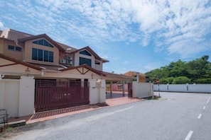 A two-story house with a gated driveway and a clear sky. - Rivermoon Kuantan (Kuala Kuantan)