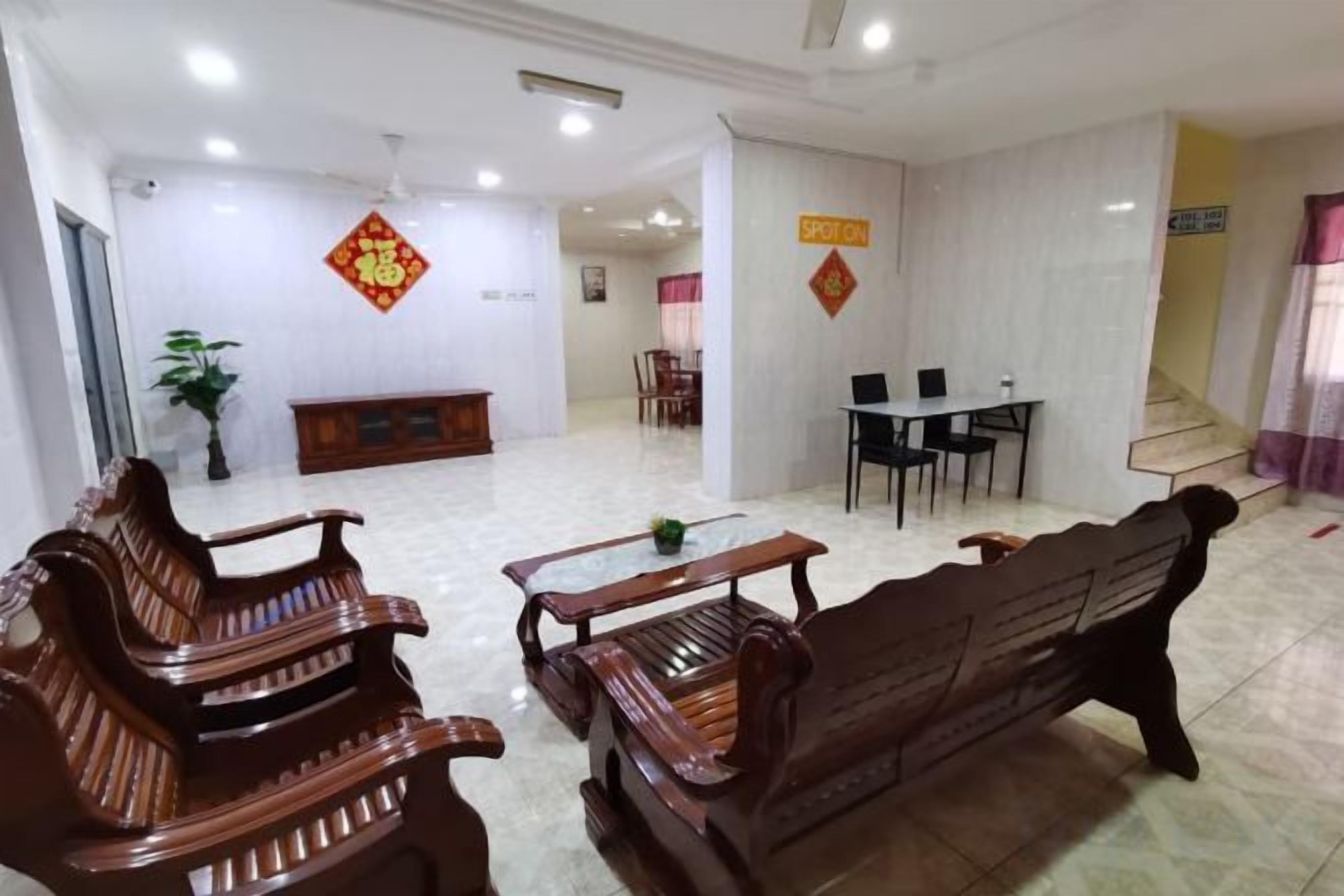 A lobby with wooden benches, a reception desk, and a staircase.