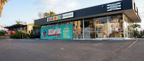 A storefront with a sign advertising 'Oceanside USA' and 'Vintage Modern Handmade Antique Gifts'.