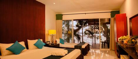 A hotel room with a large bed, a desk, and a view of the outdoors.