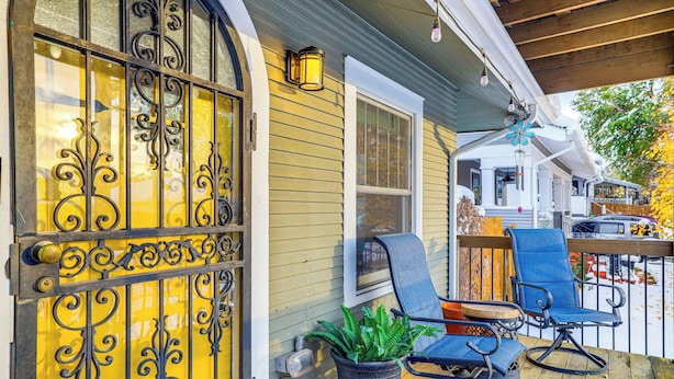 A wooden deck with outdoor seating, a potted plant, and a decorative metal gate. - 1 Mi to Dtwn Casper: Homey Getaway w/ Yard! (Casper)