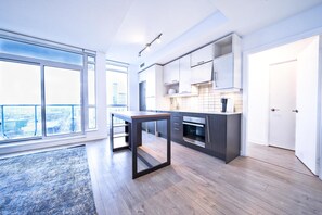 Classic Apartment | Private kitchen | Full-sized fridge, microwave, oven, stovetop - RivetStays - The Social (Toronto)