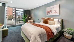 A modern bedroom with a large bed, a view of the city through floor-to-ceiling windows, and a cityscape view. - LUXURY LIVING - ICONIC ST KILDA BEACH LOCATION ** ONE MONTH SHORT STAYS **
 (St Kilda)