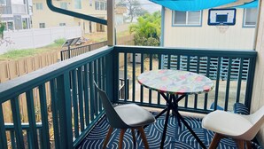 A covered outdoor area with a table and two chairs, a blue awning, and a basketball hoop. - Westside Magic 3bed 2 bath house in terrific westside of oahu!  (Nanakuli)