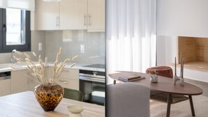 A modern kitchen with light-colored cabinets, a white pendant light, and a vase with dried plants on the counter. - Prestigious 3BR Apartment in Marousi (Marousi)