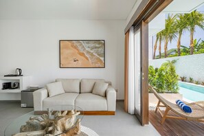Deluxe Suite, Pool View | Living area | Smart TV