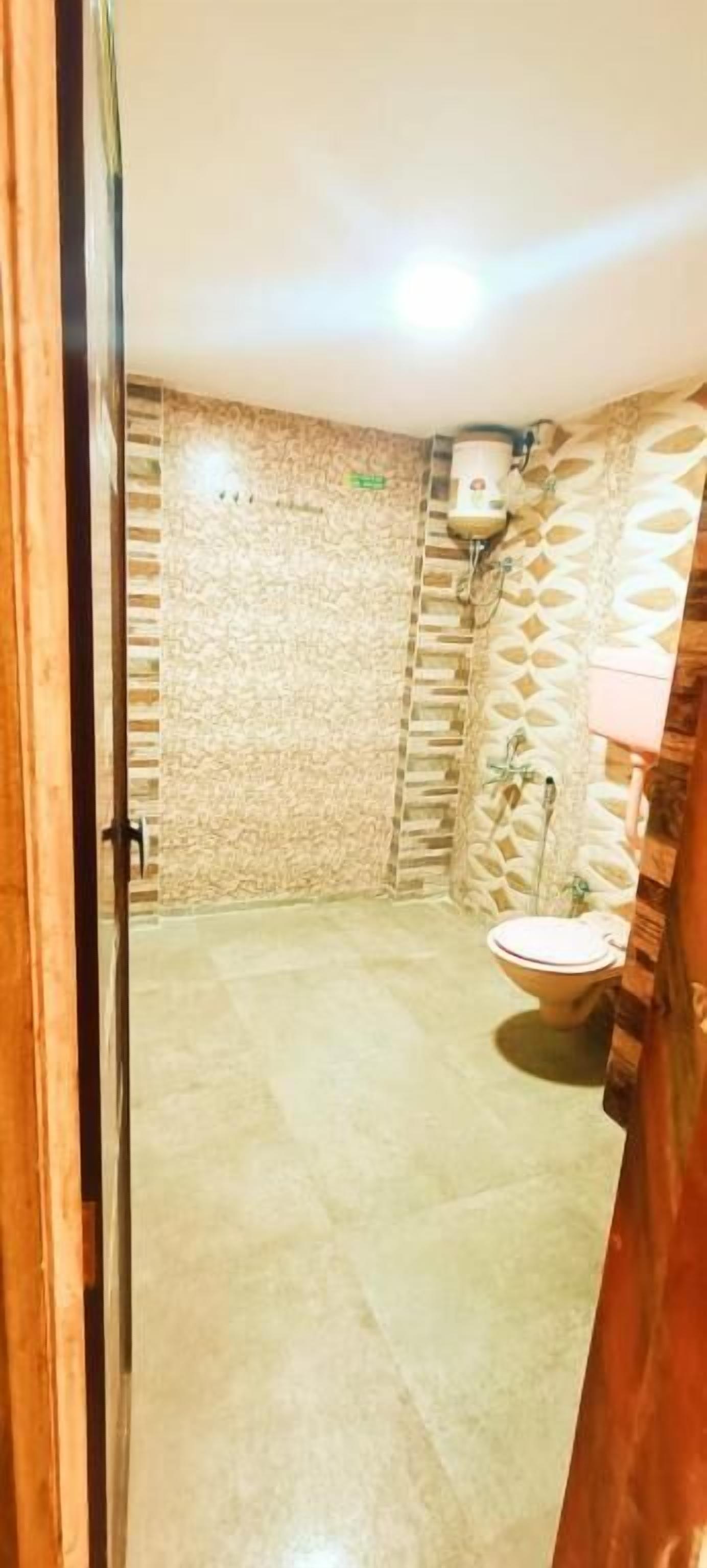Une salle de bain avec un mur en pierre, un lavabo et un espace douche.
