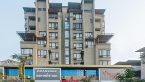 A multi-story building with a flat facade, air conditioning units, and balconies. - Pheonix By Glitz Hotels (Panvel)