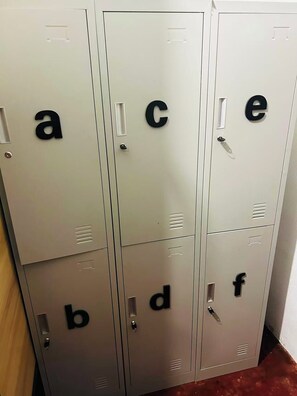 A row of metal lockers with letters on the doors. - Mimosa Inn Nong Khiaw (Nong Khiaw)