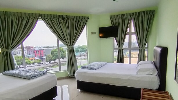 A hotel room with two beds, a TV, and a view of the outside. - Hotel O Seremban Near SnowLim Wonderland Formerly M&N Hotel (Seremban)