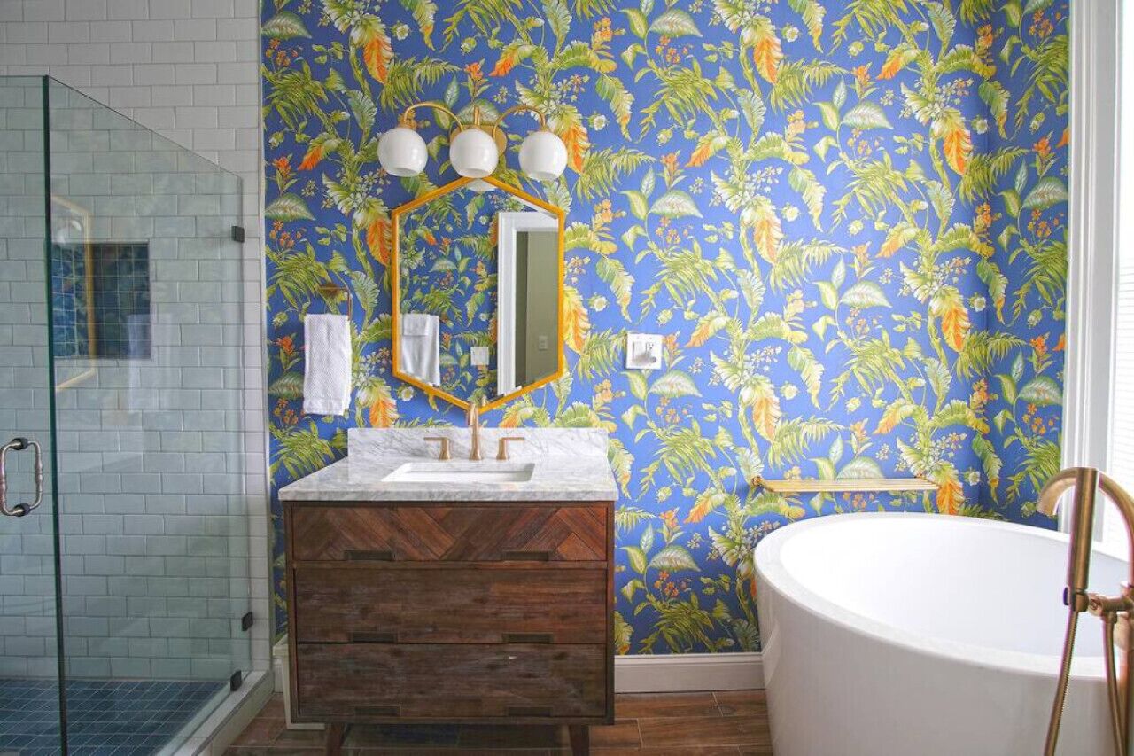 A bathroom with a shower, a sink with a mirror, and a bathtub.
