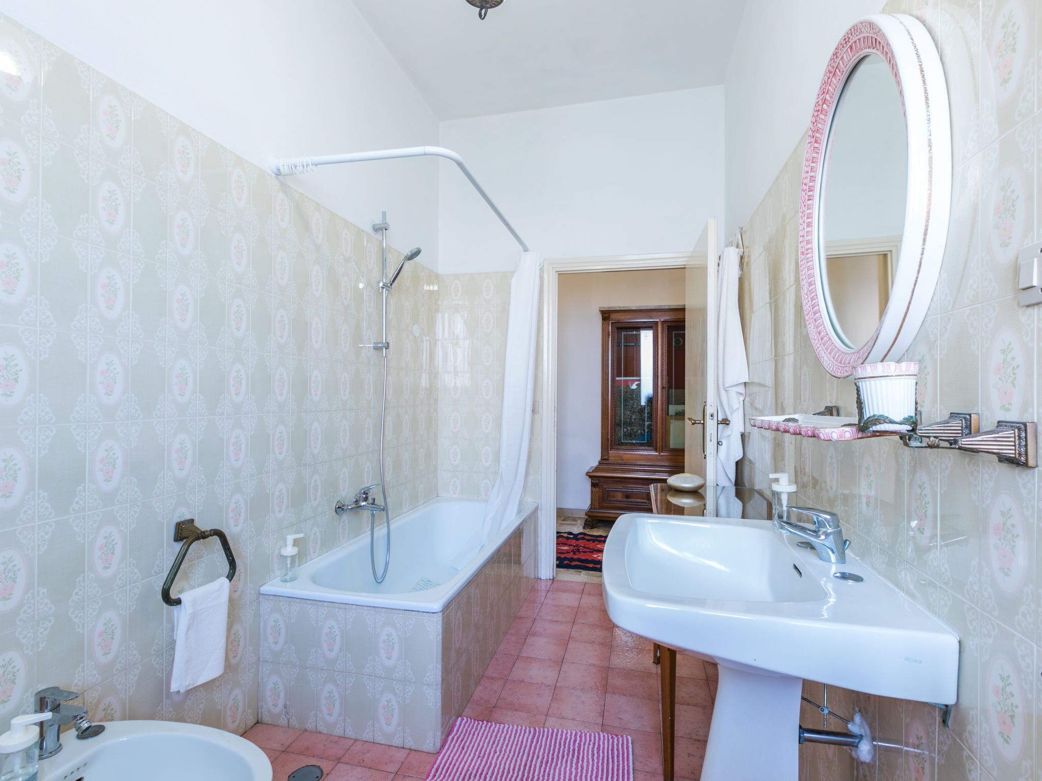 A bathroom with a bathtub, a sink, and a shower.