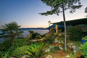 Escape to a serene coastal haven with lush gardens, scenic pathways, and breathtaking views of the calm sea.