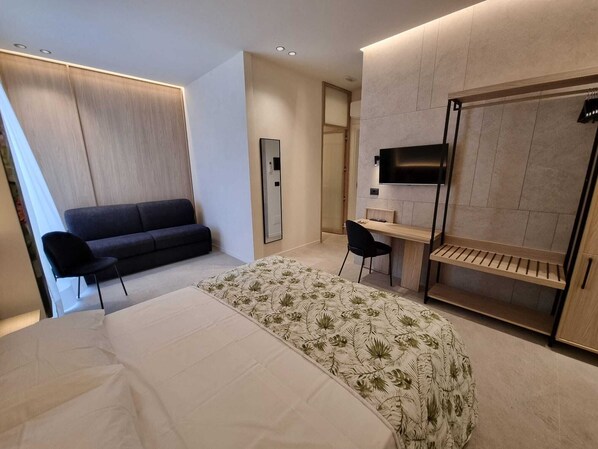 Deluxe Quadruple Room, Private Bathroom | Minibar, in-room safe, desk, laptop workspace