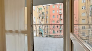 A view from a balcony with a metal railing, overlooking a residential area with multi-story buildings. - Apt With Gym in Bovisa Milan (Milan)