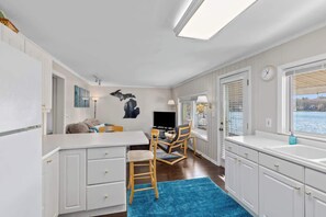 Cozy retreat with a kitchenette, dining area, and large window offering a view of the outdoors.