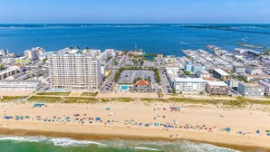 A coastal cityscape with a beachfront hotel, a marina, and a dense urban area with various buildings. - Ocean Pines Hideaway (Ocean Pines)
