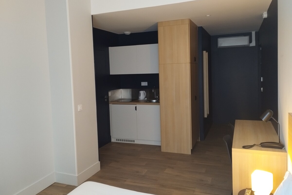 A compact kitchen with a built-in oven and a small countertop.