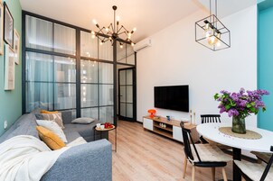 Design appartement, 2 slaapkamers, balkon, uitzicht op binnenplaats | Woonruimte | Een 70-inch smart-tv met kabelzenders