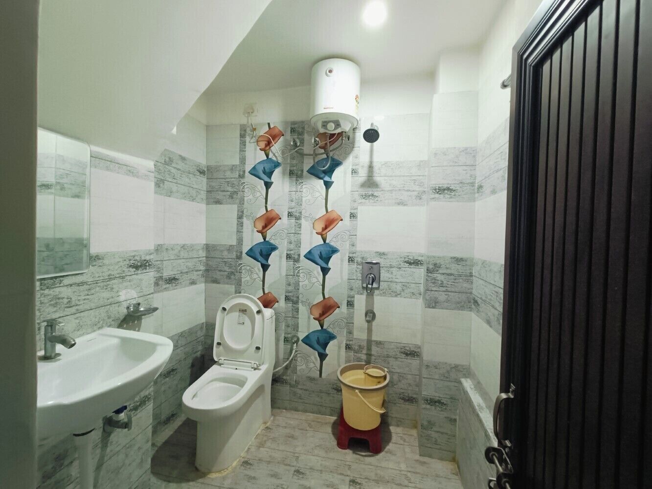 A bathroom with a sink, toilet, and shower.