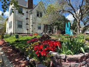A two-story house with a garden in front.