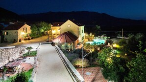 A stone house with a swimming pool, surrounded by greenery and mountains in the background. - Authentic Dalmatian Hillside Escape With Pool, Sauna & BBQ (Sestanovac)