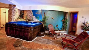A spa area with a hot tub, wooden chairs, and a decorative wall with fish and plants. - Authentic Dalmatian Hillside Escape With Pool, Sauna & BBQ (Sestanovac)