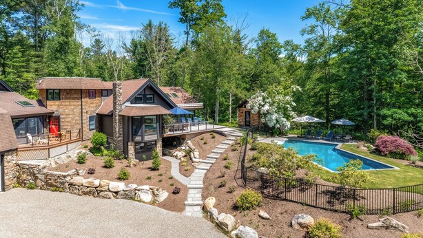 A modern resort with multiple cabins, a swimming pool, and a well-maintained garden.