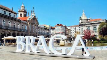Experience the charm of Braga's historic architecture in this picturesque plaza, surrounded by ornate facades and red-tiled roofs.
