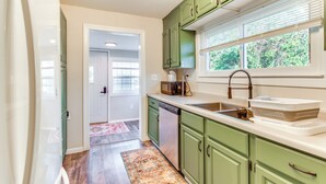 A kitchen with green cabinets, a dishwasher, a sink, and a window with blinds. - Hike, Boat & Fish: Dog-friendly Robinson Home (Robinson)