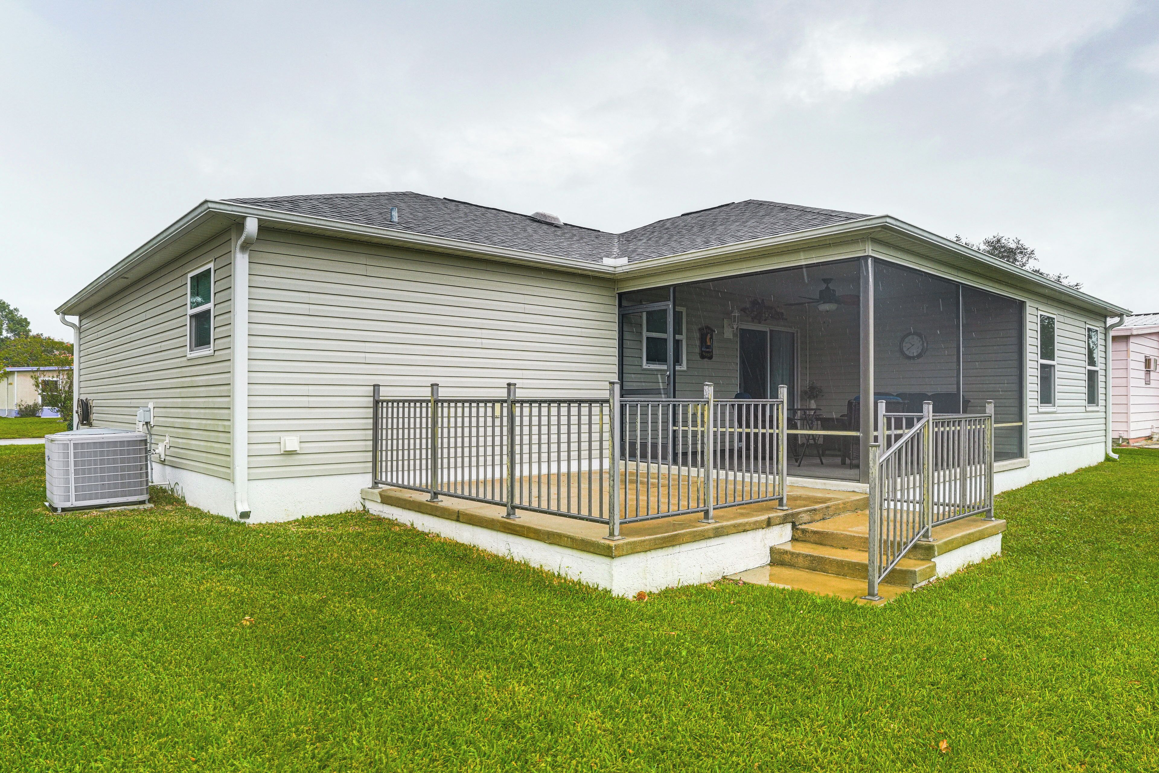 A single-story house with a covered porch and a small front yard.