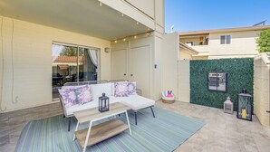 A covered outdoor seating area with a sofa, cushions, and a table. - Furnished Patio, Pool Access! Scottsdale Retreat (Scottsdale)