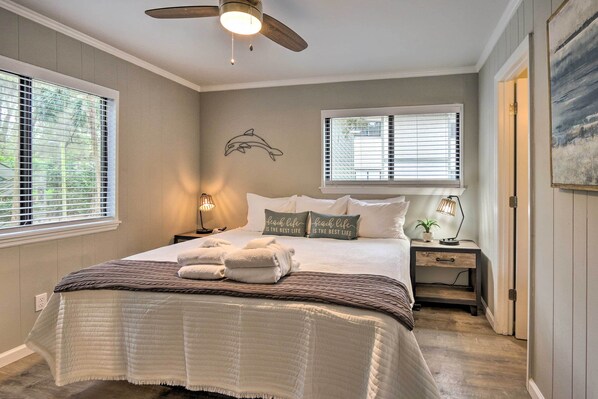 A bedroom with a bed, two bedside tables, a ceiling fan, and a window with blinds. - < 1 Mi to Beach: Hilton Head Condo w/ Pool Access! (Hilton Head Island)