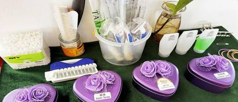 A collection of personal care items including a comb, a hairbrush, and various bottles, along with several small purple containers labeled 'Bath Soap.'